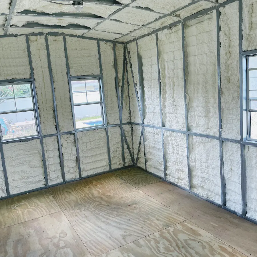 Closed-cell spray foam insulation applied to wall cavities in a residential project in Alpena